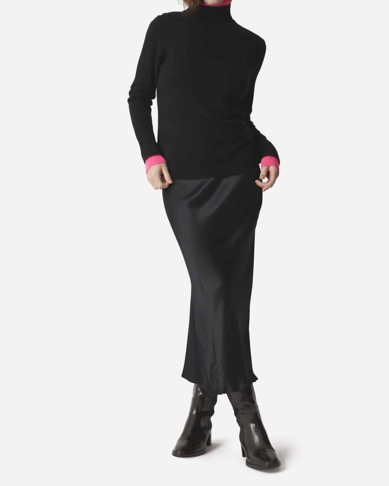Front of a model wearing a size L Contrast Roll Neck Sweater in Black in Black by Brodie Cashmere. | dia_product_style_image_id:363168